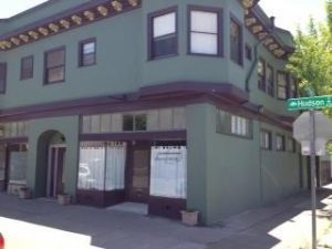 A photo of Danspace's building. Hudson Street sign is visible.