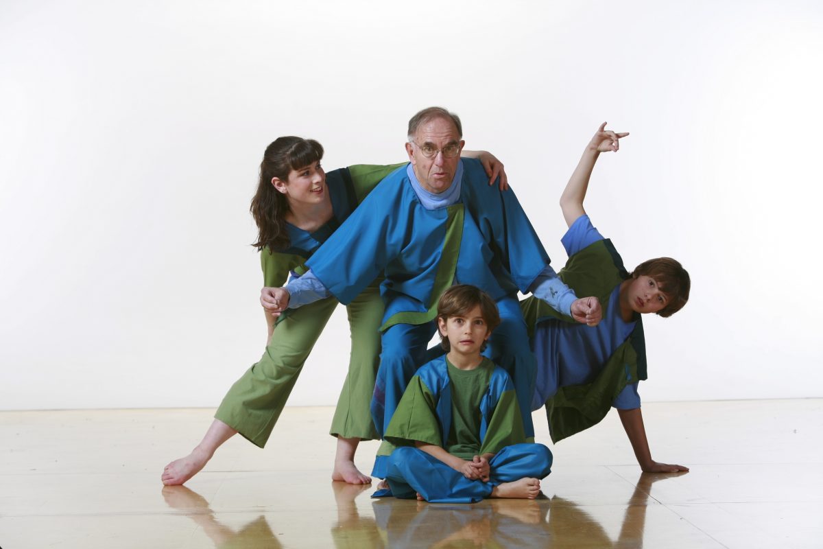 4 dancers in blue and green costumes in various poses