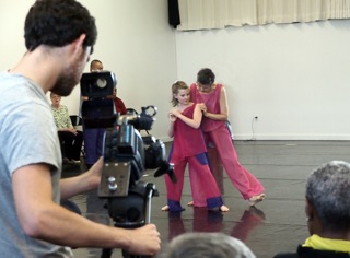 A photo of a photoshoot. Photographer is visible and two dancers in costumes.