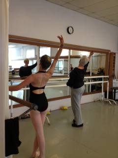 Beth Hoge giving corrections during class with a teen student practicing next to her.