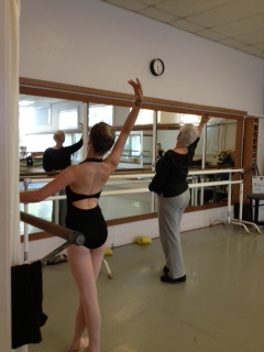 Beth Hoge giving corrections during class with a teen student practicing next to her.