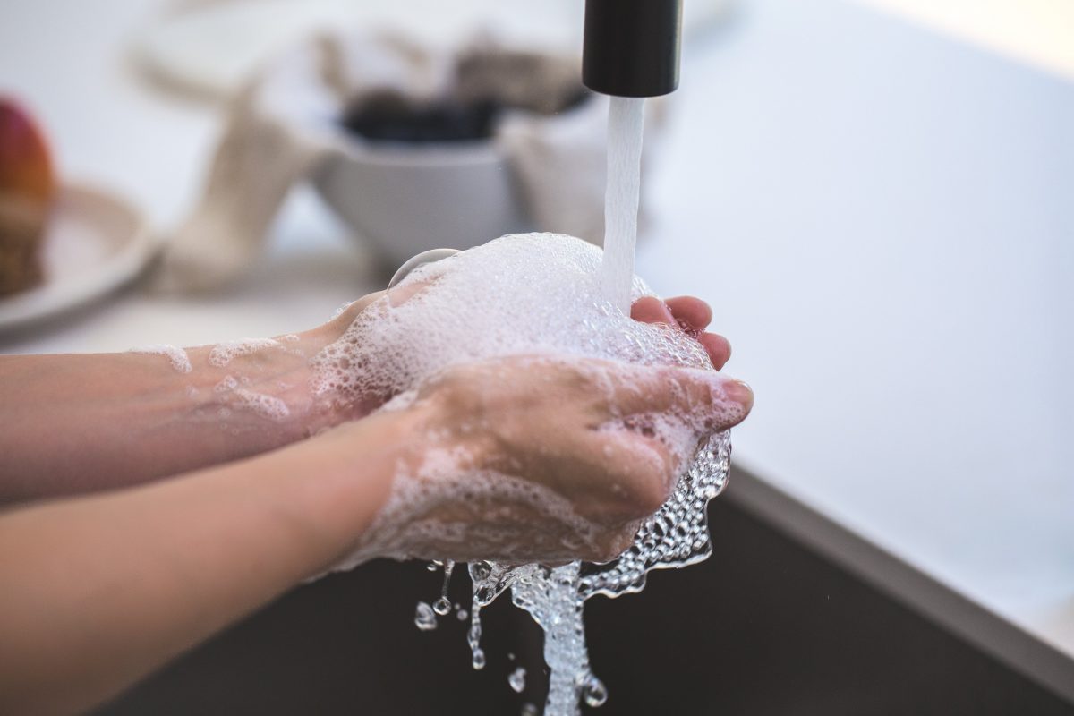 stock photos close up on hands washing at a sink.