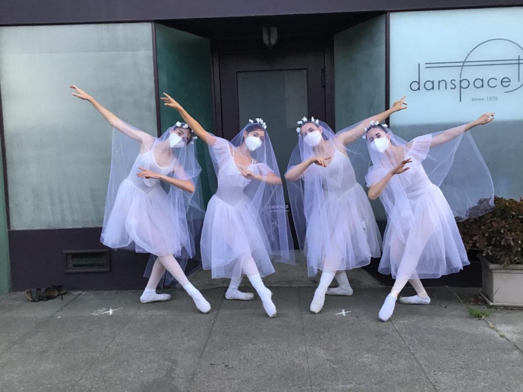 4 dancers stand in costume for Giselle outside of Danspace's front door.