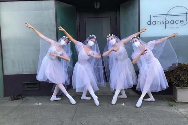 4 dancers stand in costume for Giselle outside of Danspace's front door.