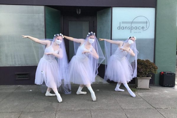 3 dancers stand in costume for Giselle outside of Danspace's front door.