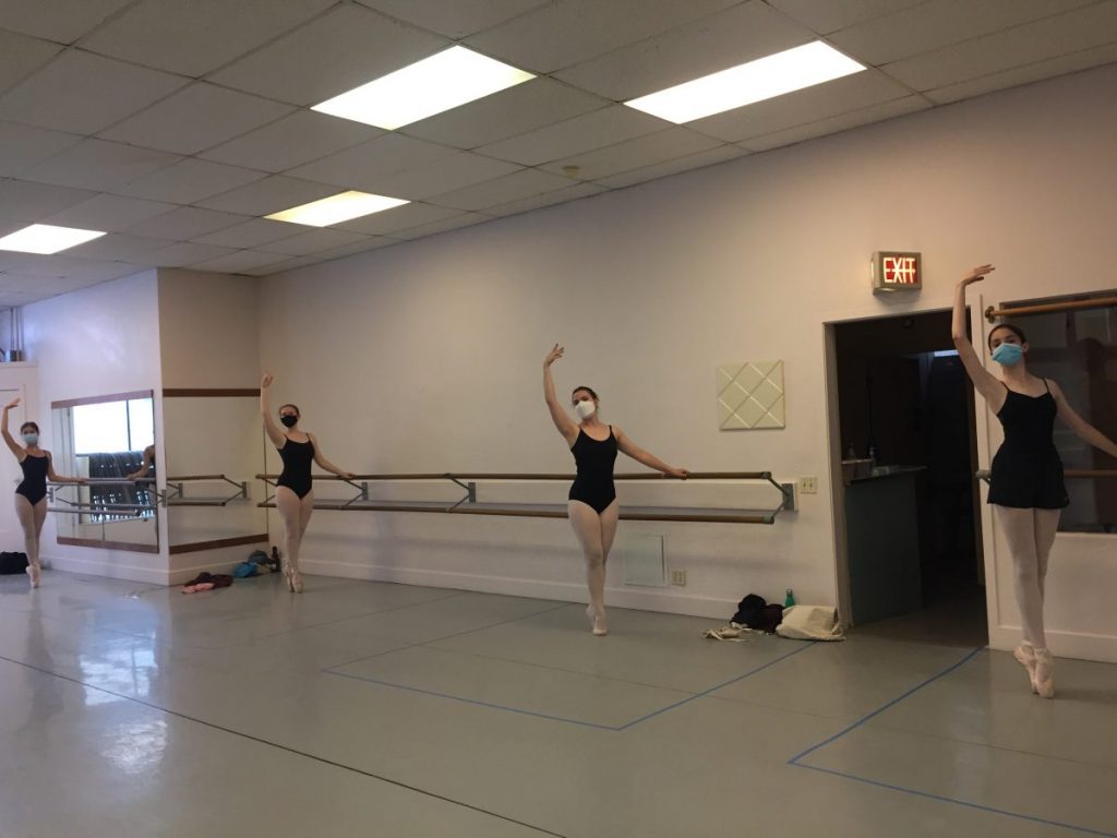 4 teen dancers in class in masks pose in sous-sous.