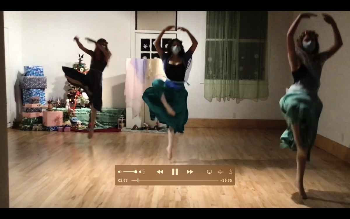 A screenshot of 3 dancers in costume mid pirouette performing a Nutcracker variation in the studio.