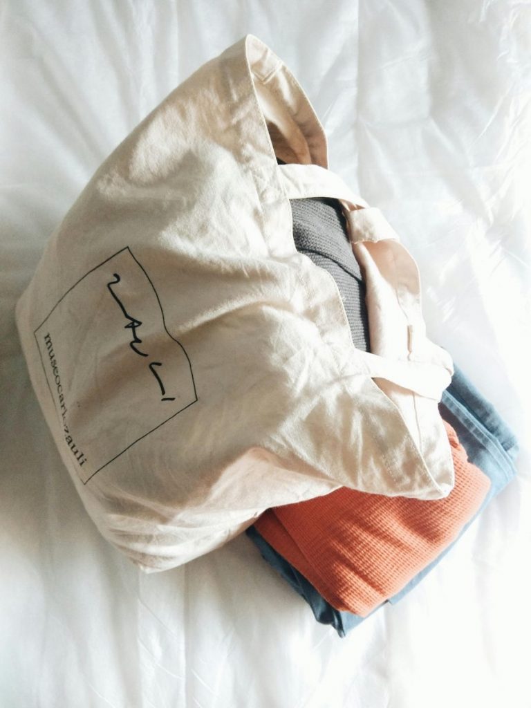 tote bag with folded close underneath it