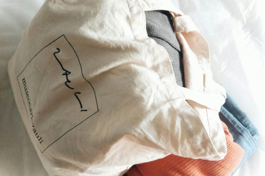 tote bag with folded close underneath it